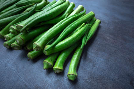 Fresh okra, lady finger, on gray table.の写真素材