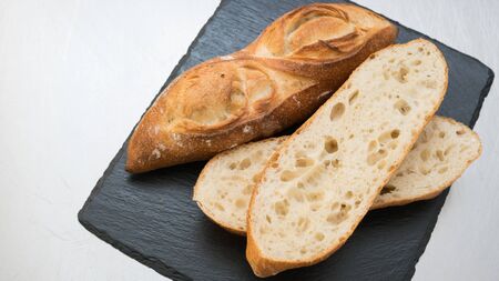 Bageutte and sliced bread on black slate