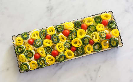 Vegetable quiche in tray ready for bakingの写真素材