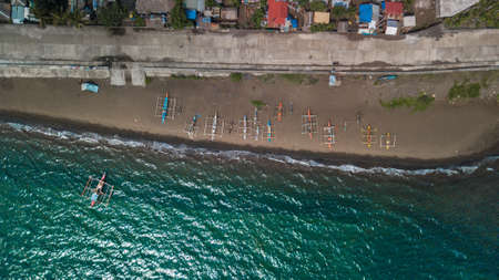 Seawater, boats, and houses, as seen from above photo taken by drone