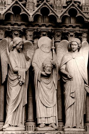 Stone statues on the front porch of Notre-Dame cathedral - Paris, Franceの写真素材