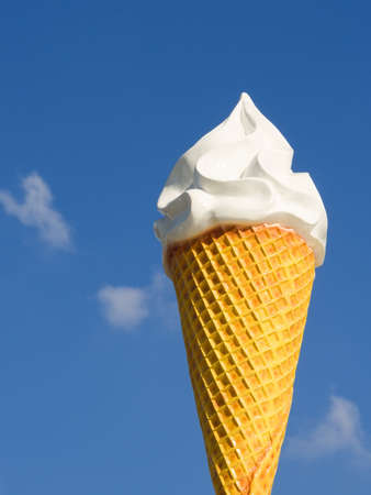 Giant ice cream cone over a clear blue sky at a fun fair