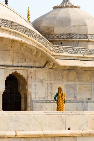 An indian woman dressed in a yellow sari at Amber fort - Jaipur, Rajasthan, Indiaの写真素材