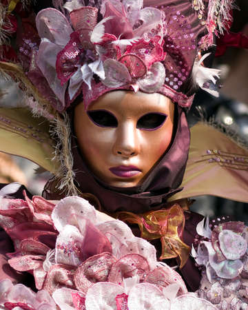 Performers in costume gathered on a quay of the river Seine for a Venetian carnival parade in Paris, Franceの写真素材