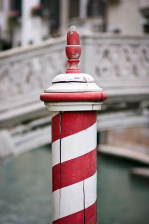 Wooden dock post painted with red and white stripes - Venice, Venezia, Italy, Europeの写真素材