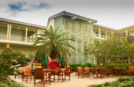 Woman sitting at a terrace of Camana Bay around Christmas time, Grand Caymanのeditorial素材
