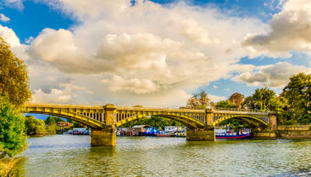 Boats moored by Twickenham Bridge spanning over the river Thames, London U.Kの写真素材