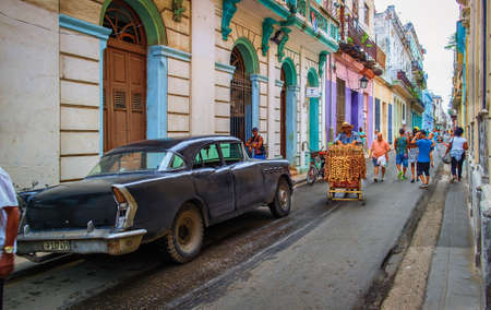 Havana, Cuba, July 2019, urban scene in the oldest part of the city with a black American 1950's car parked in Calle Cubaのeditorial素材