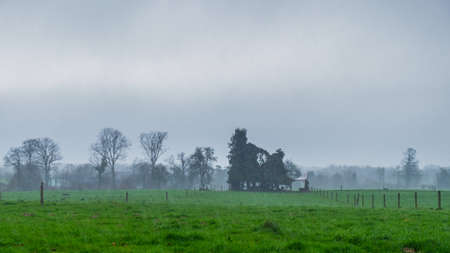 Heavy rain falling over the Normandy countryside in winterの写真素材
