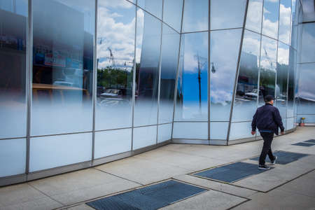 New York City, USA, May 2019, man walking by the facade of the IAC building in the West Chelsea neighborhood of Manhattanのeditorial素材