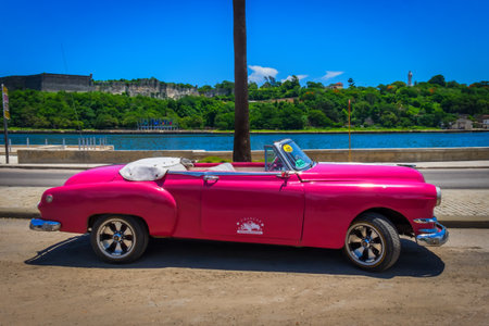Havana, Cuba, July 2019, view of a pink convertible Chevrolet parked used as a rental car for touristsのeditorial素材