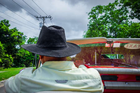 Havana, Cuba, July 2019, close up of the back of a taxi driver with a hat drivingのeditorial素材