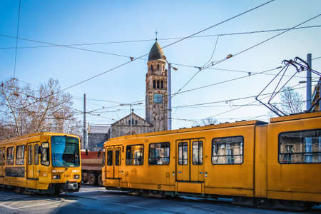 Budapest, Hungary, March 2020, view of two tramways passing by Saint Vincent de Paul church by Mester and Haller Streets in the 10th district of the capitalのeditorial素材