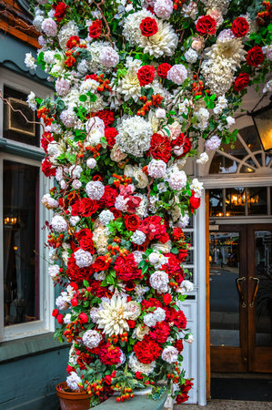 London, UK, Aug 16th 2025, view of an entrance floral display at the Dog and Fox, a pub, and hotel in Wimbledon Village high streetの写真素材