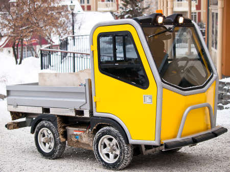 Specialized utility vehicule for ski village going up hill in snowの写真素材