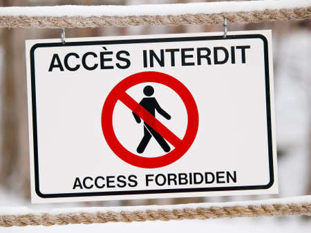 Bilingual access forbiden sign on rope in winterの写真素材