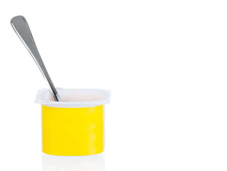 yogurt pot with spoon isolated on white backgroundの写真素材