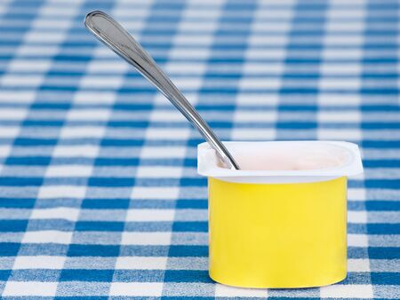 yogurt pot with spoon の写真素材