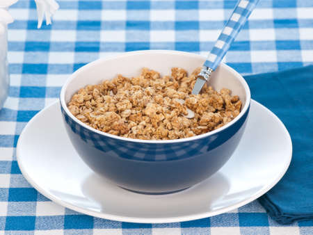 Breakfast cereal  on the  table with milk and flowersの写真素材