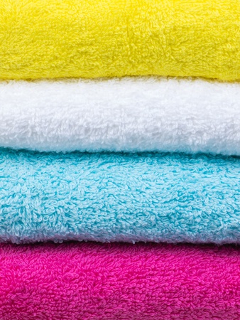 Fresh towels stack closeup front view on white backgroundの写真素材