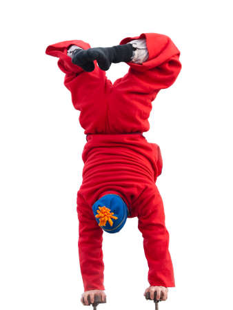 Acrobat male standing on hands isolated on white backgroundの写真素材