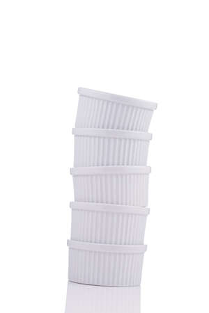 White ramekin dishes unstable stack isolated on white backgroundの写真素材