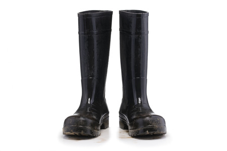 Wet dirty Mud boots isolated on pure white background front viewの写真素材