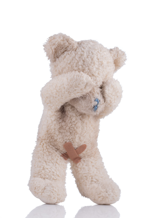 Toy bear with adhesive bandages on his private parts 3/4 viewの写真素材