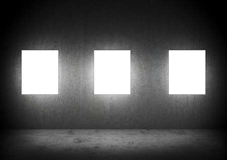Blank frames in a dark Concrete roomの写真素材