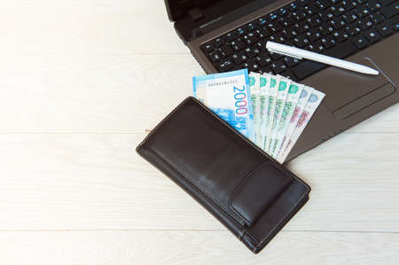 The workplace of business people. Laptop and money.の写真素材