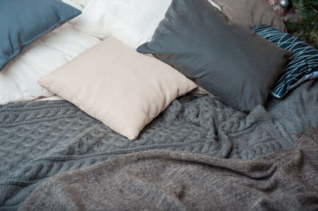 Pillows and blankets are on the bed.