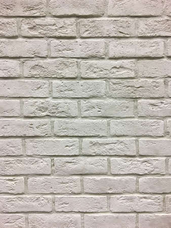 Artificial stone. Decorative wall of artificial torn stone. Stone masonry in geometric pattern as...
