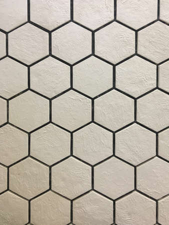 Artificial stone. Decorative wall of artificial torn stone. Stone masonry in geometric pattern as...