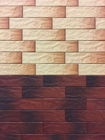 Artificial stone. Decorative wall of artificial torn stone. Stone masonry in geometric pattern as...