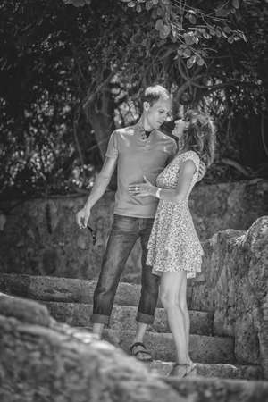 Happy couple on vacation. Lovers are laughing. Happy guy and girl. Lovers enjoy each other in the evening park.の写真素材