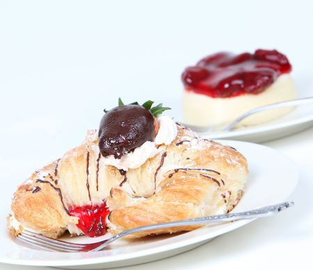 Cream filled croissant with chocolate strawberry and cheesecakeの写真素材