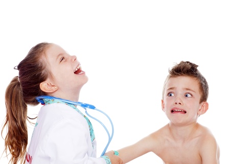 Young girl doctor laughing as she gives a shot to young boyの写真素材