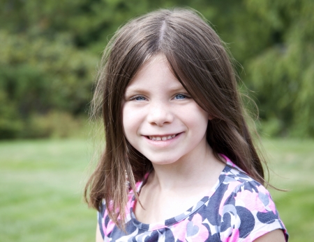 Pretty young girl portrait smiling outdoorsの写真素材