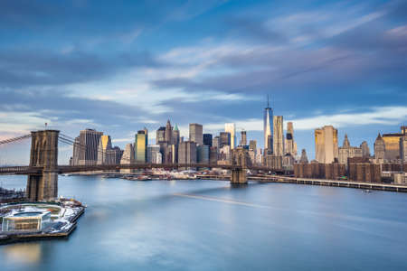 Long exposure of Manhattan Island with milky water and streaky cloudsの写真素材