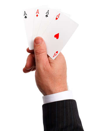 Man's hand holding a trump, the four aces