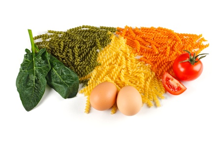 Bunch of naturally colored pasta with spinach, egg and tomatoの写真素材