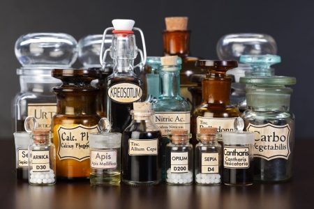 Various pharmacy bottles of homeopathic medicine on dark backgroundの写真素材