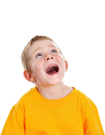 Surprised boy with open mouth looking up to white copy spaceの写真素材