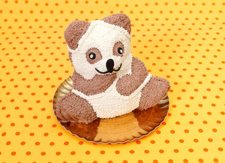 White and brown chocolate teddybear cake on dotted backgroundの写真素材
