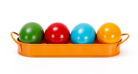 Colorful painted Easter eggs in orange metallic trayの写真素材