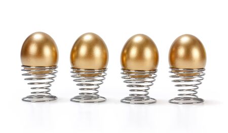 Four golden eggs in metallic spiral egg cups
