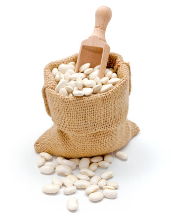 Loose dry haricot beans in burlap sackの写真素材