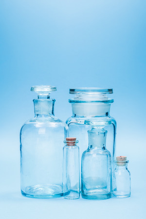 Clear empty glass reagent bottles of various sizeの写真素材