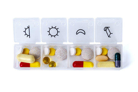 Daily drug dose - pills organized in a pill boxの写真素材