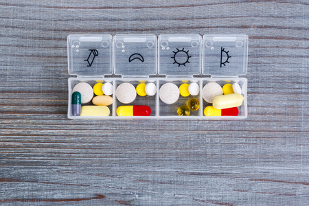 Daily drug dose - pills organized in a pill boxの写真素材
